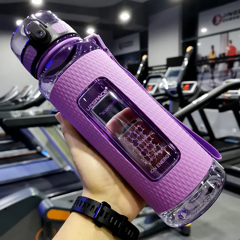 Blue portable sport water bottle with black lid on a gym bag.