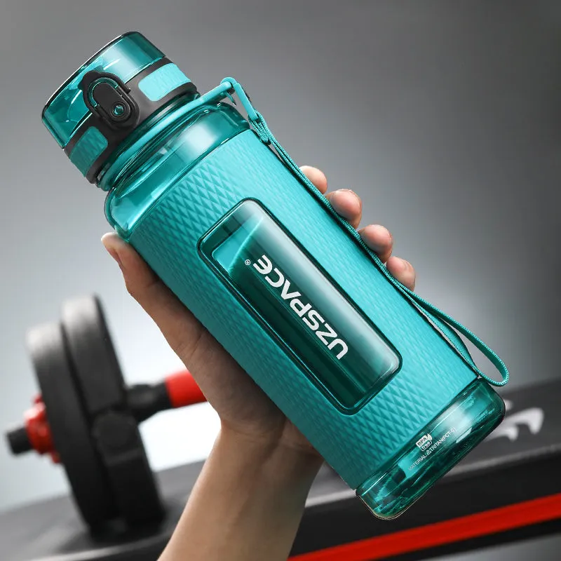 Blue portable sport water bottle with black lid on a gym bag.