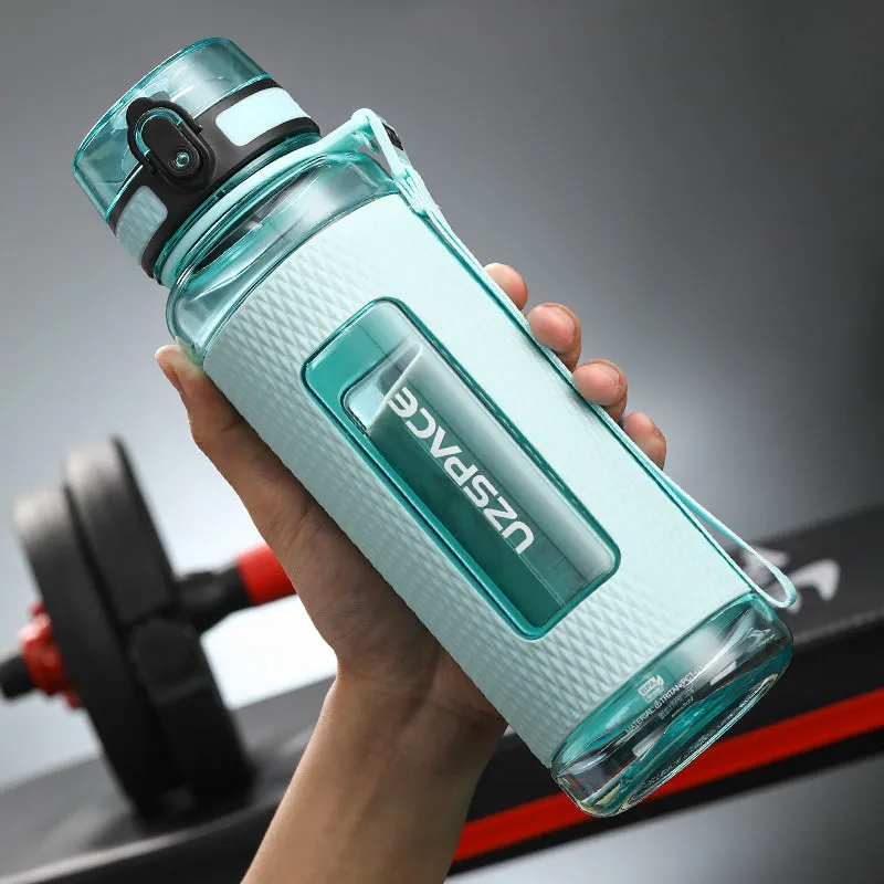 Blue portable sport water bottle with black lid on a gym bag.