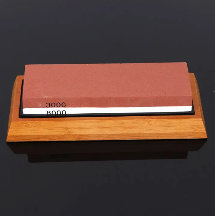 White corundum kitchen whetstone on bamboo base with correction stone and accessories