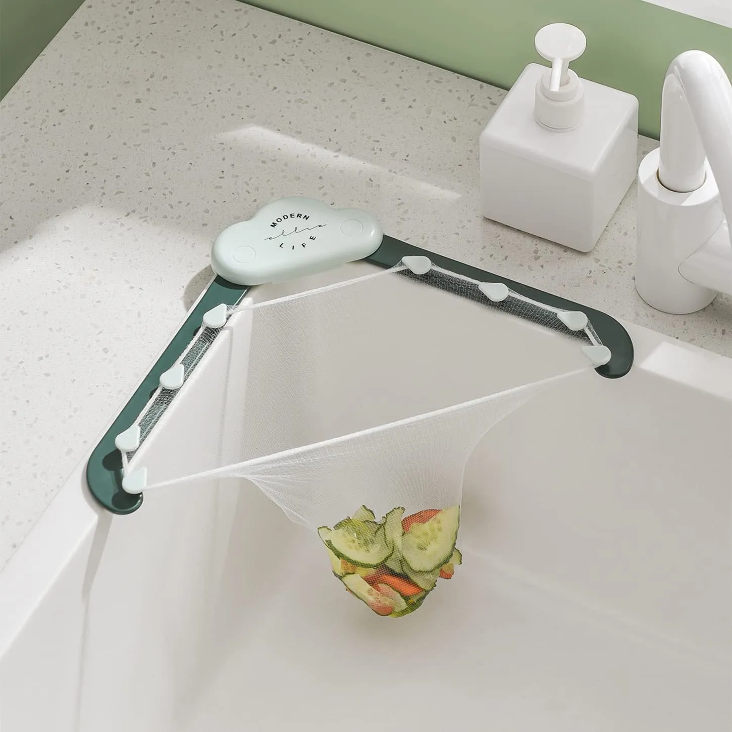 Green triangular ABS plastic sink drain rack with elastic mesh filter net installed in kitchen sink corner.