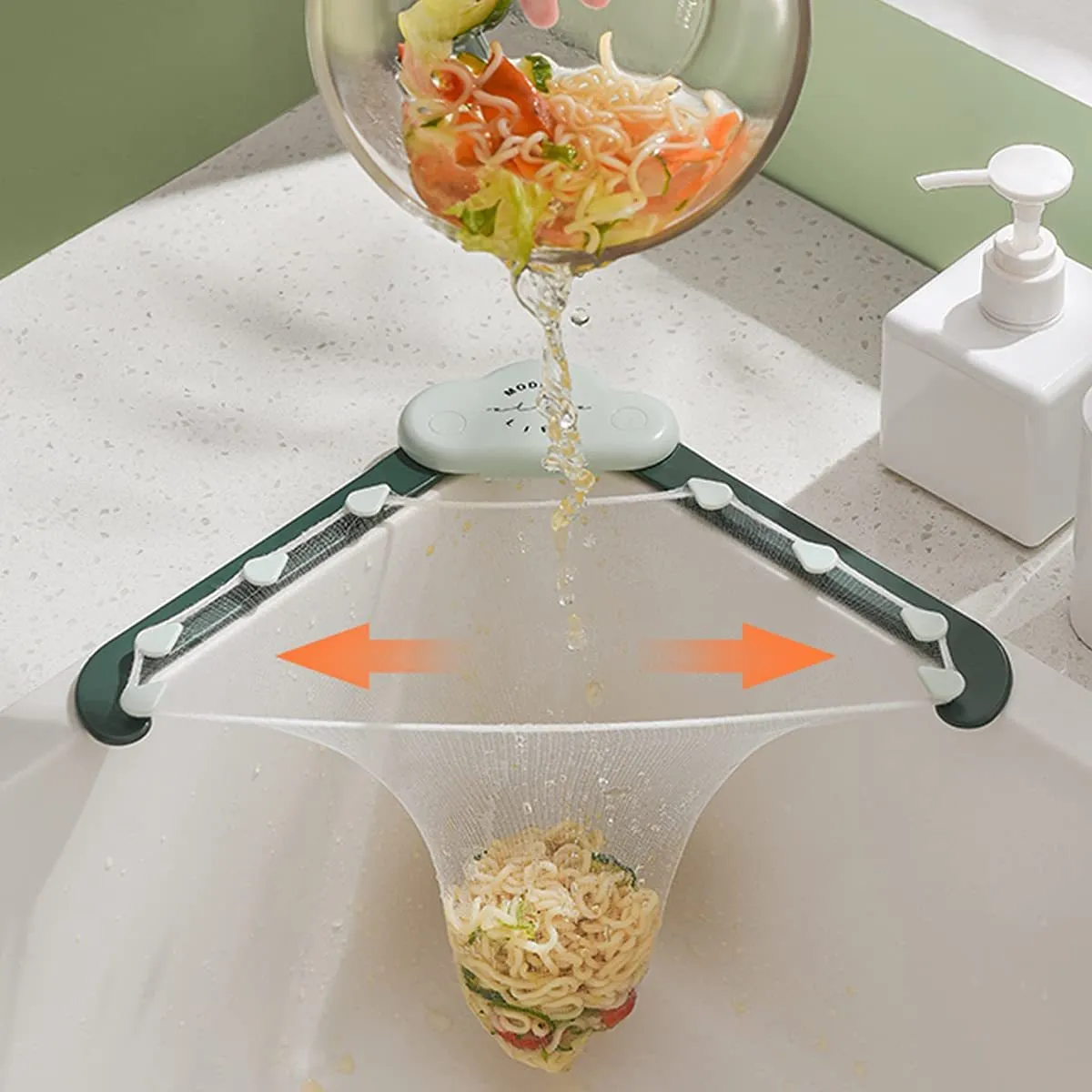 Green triangular ABS plastic sink drain rack with elastic mesh filter net installed in kitchen sink corner.
