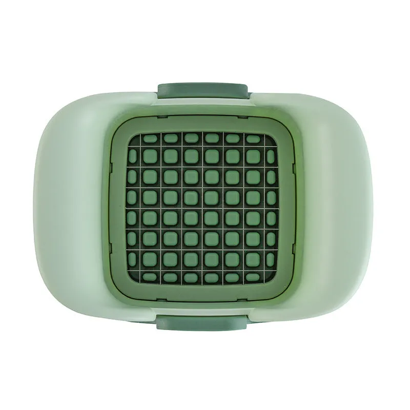 Green manual vegetable chopper with stainless steel blades for onions, potatoes, and cucumbers.