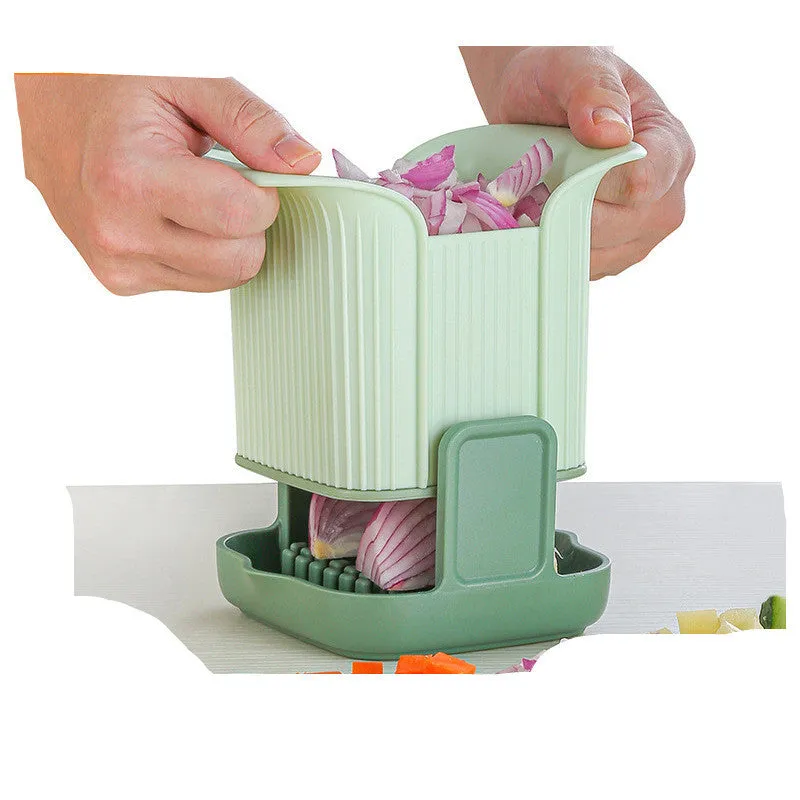 Green manual vegetable chopper with stainless steel blades for onions, potatoes, and cucumbers.