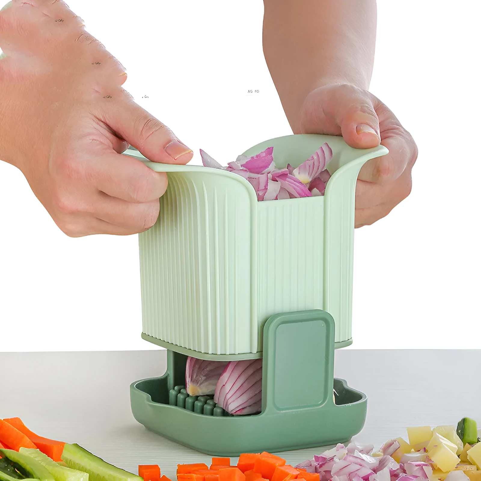 Green manual vegetable chopper with stainless steel blades for onions, potatoes, and cucumbers.