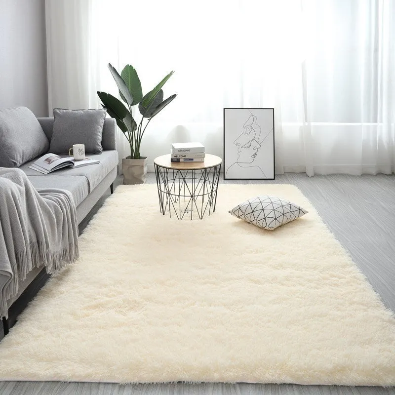 Nordic style rectangular plush carpet in a light colour on a wooden floor, showing fluffy texture.