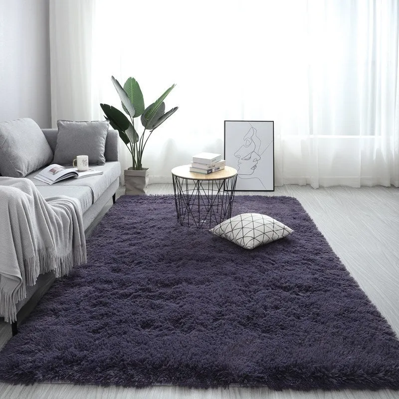 Nordic style rectangular plush carpet in a light colour on a wooden floor, showing fluffy texture.