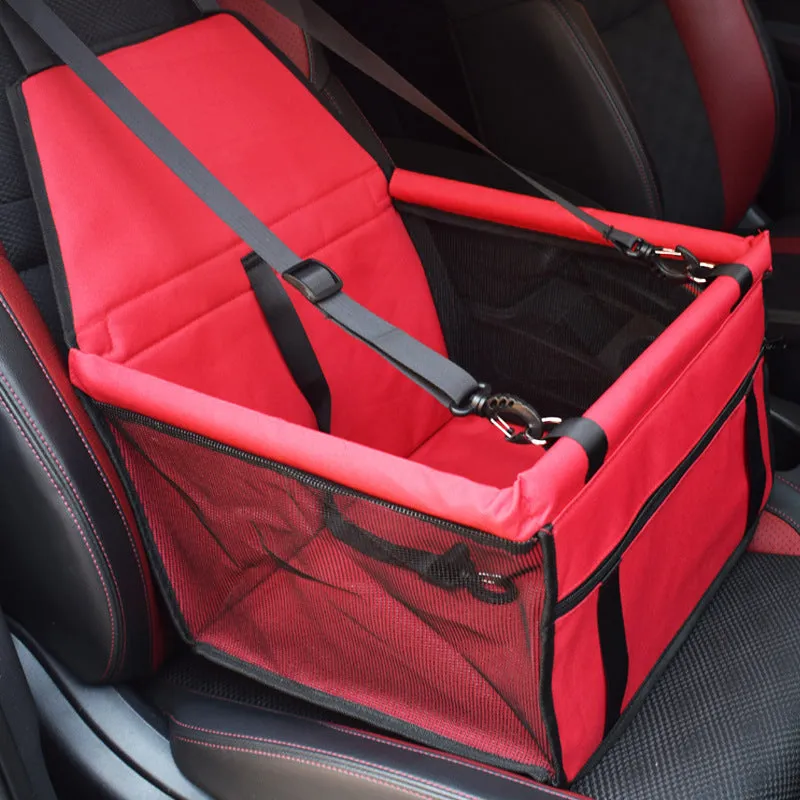 Red cloth pet car carrier bag with geometric pattern and safety tether for dog travel