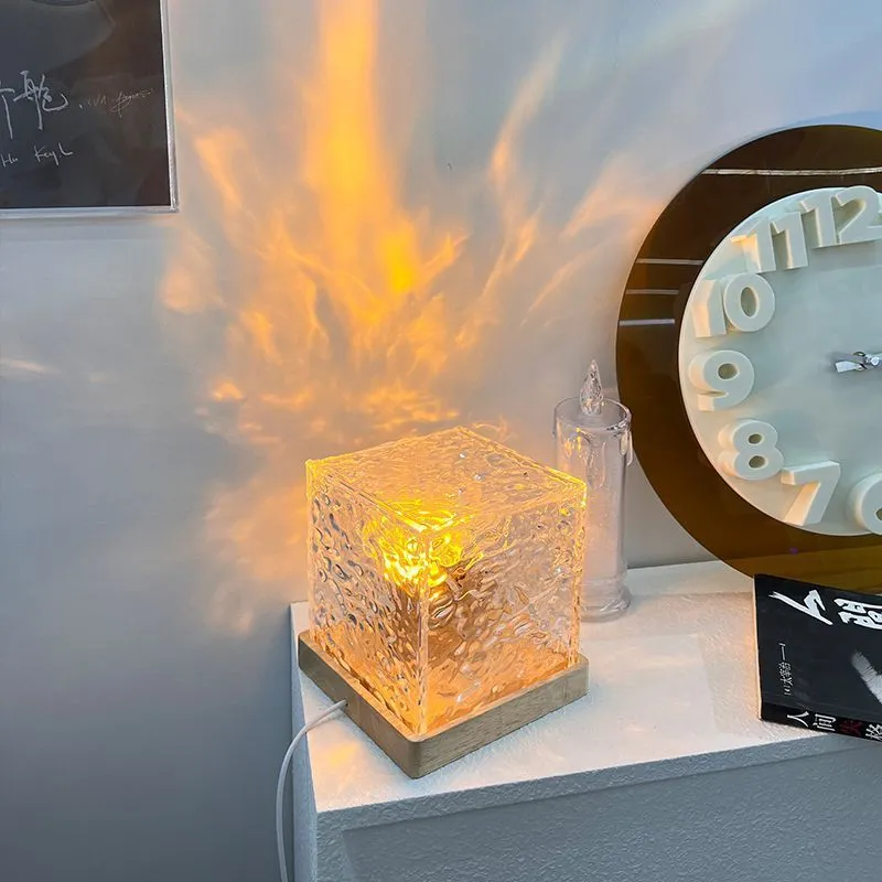 LED water ripple projection crystal table lamp with remote control on wooden surface