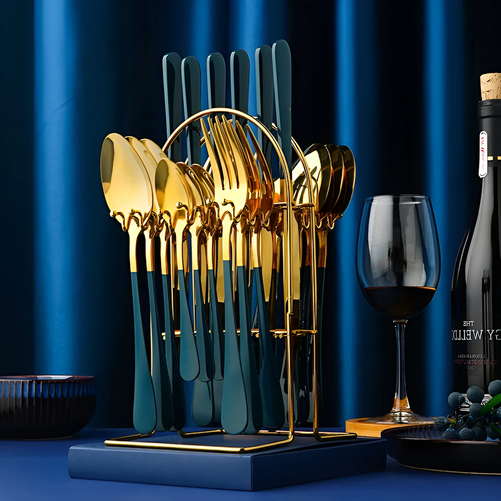Gold stainless steel knife fork spoon cutlery set with storage rack on a table.