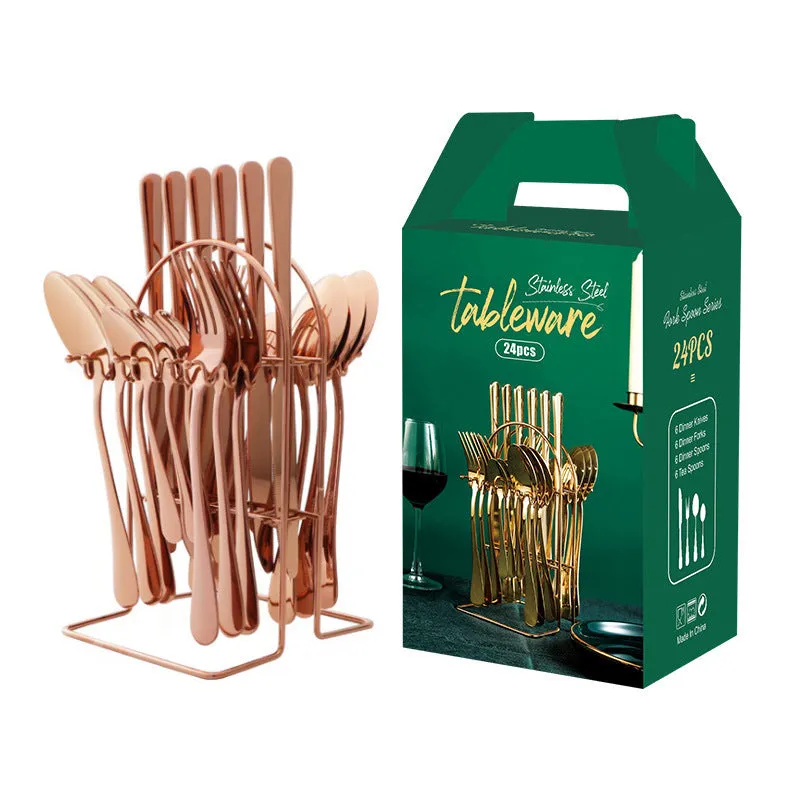 Gold stainless steel knife fork spoon cutlery set with storage rack on a table.