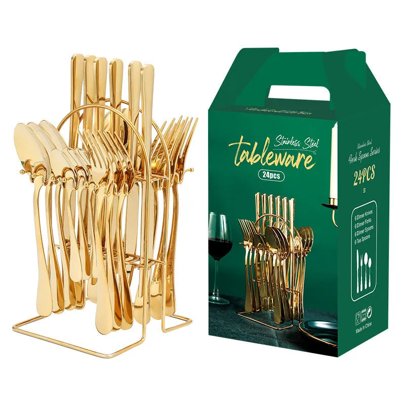 Gold stainless steel knife fork spoon cutlery set with storage rack on a table.