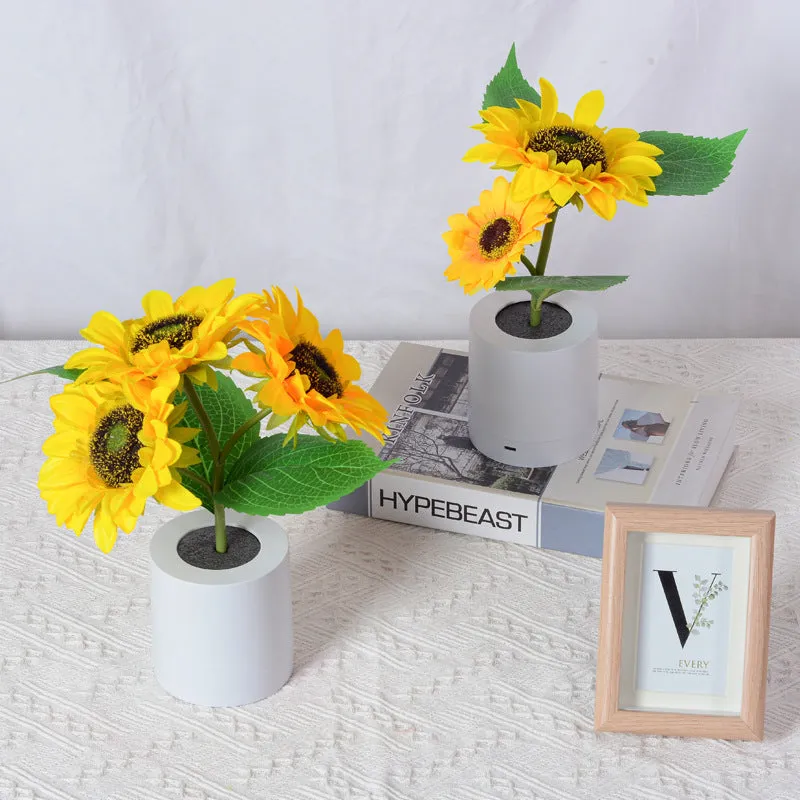 Rechargeable sunflower LED night light with artificial flower design on table