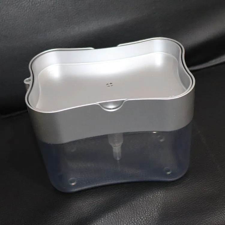 Rectangular grey plastic kitchen soap dispenser with a touch-free pump on a worktop.