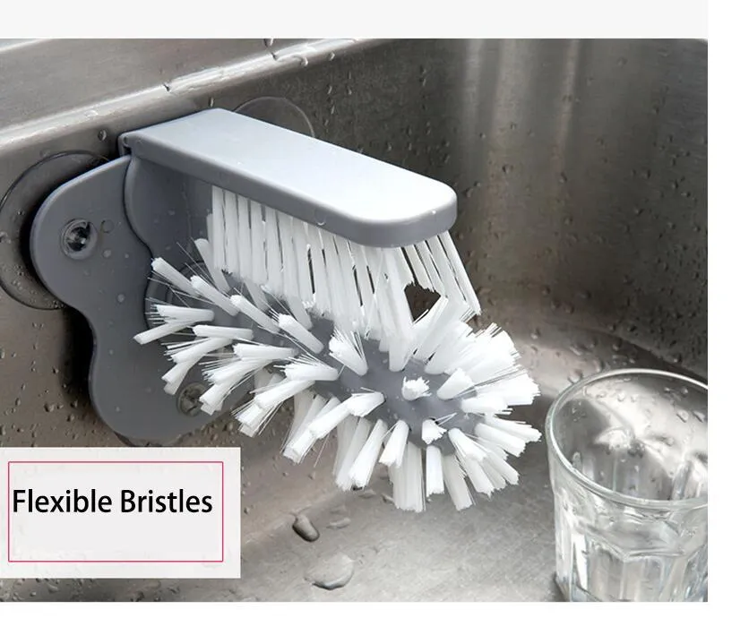 Grey kitchen cleaning brush with two brush heads and suction cups for wall mounting