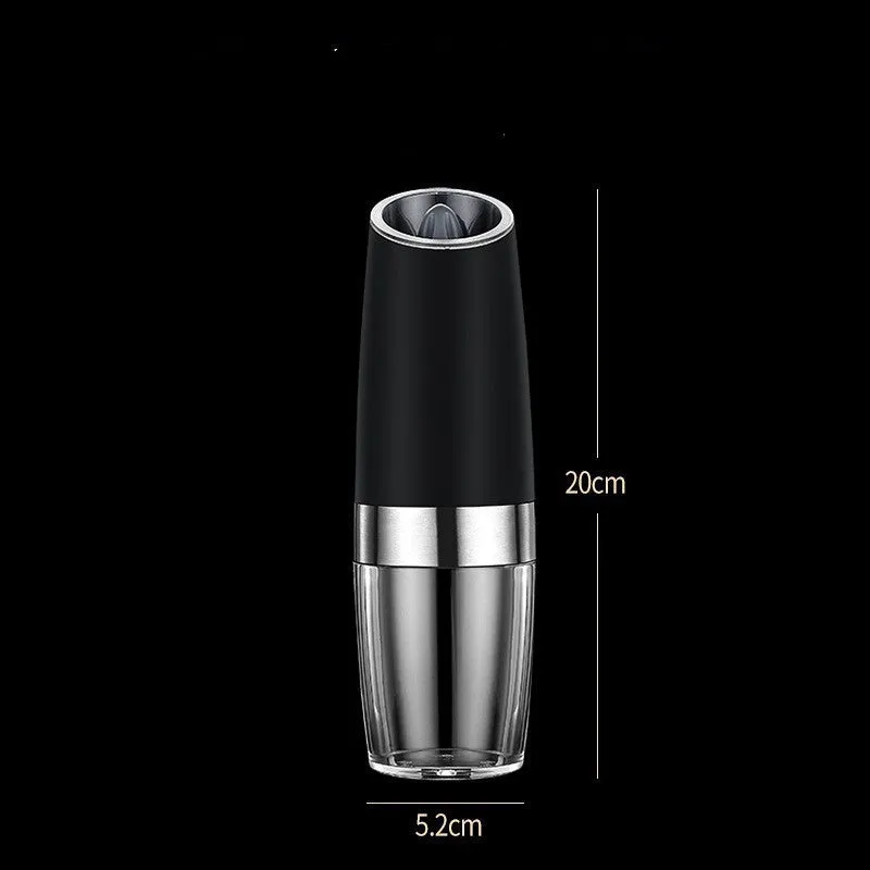 Black and silver rechargeable electric pepper grinder with clear acrylic body on a kitchen counter