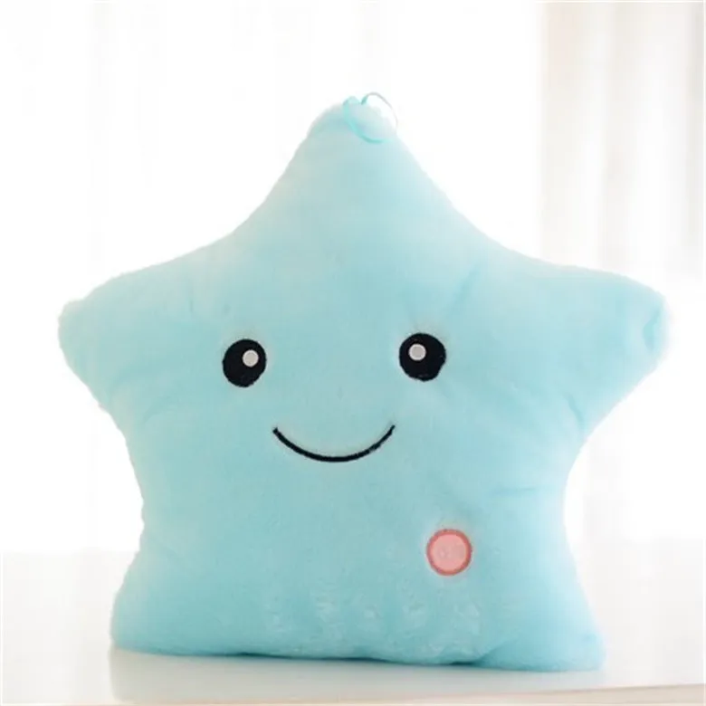 Colourful glowing five-pointed star plush pillow on a dark background, illuminated from within.