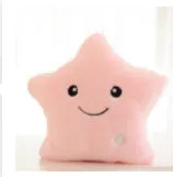 Colourful glowing five-pointed star plush pillow on a dark background, illuminated from within.