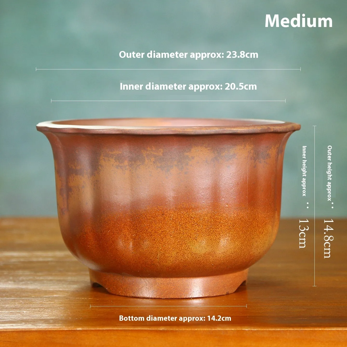 Indoor antique carved purple sand ceramic flowerpot for bonsai plants on a wooden surface.