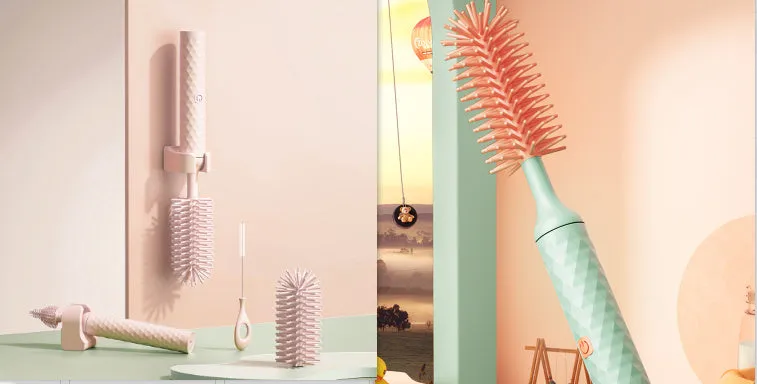 Pink and green electric rotating silicone bottle brush set for cleaning baby bottles and cups.