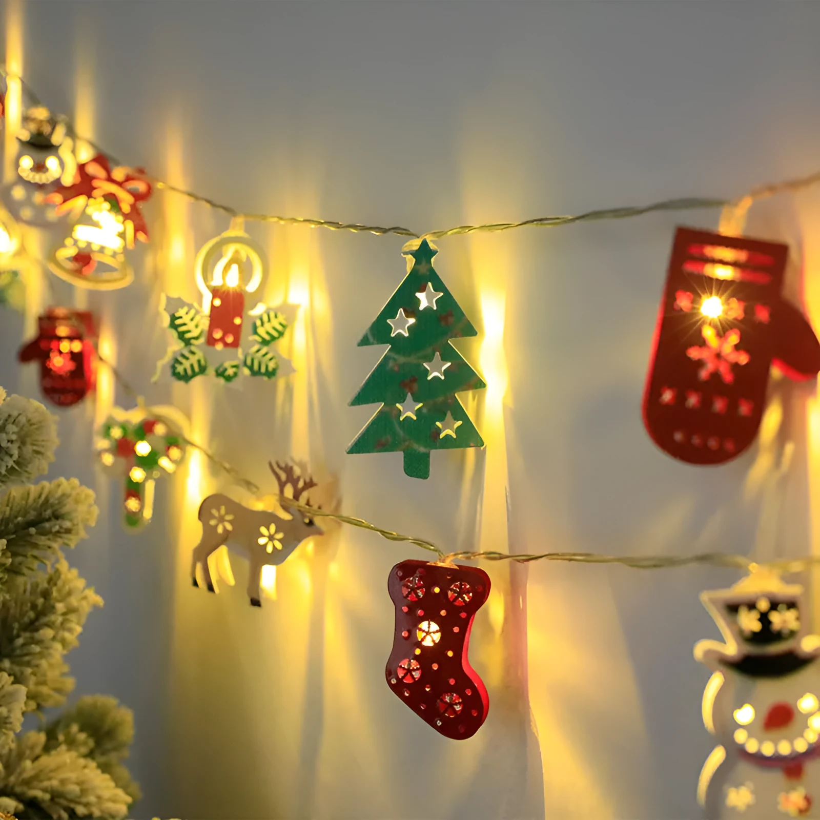 Christmas LED string lights with Santa Claus, reindeer and snowman ornaments hanging on Christmas tree