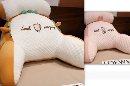 Large triangle-shaped reading cushion with embroidered design on a sofa.