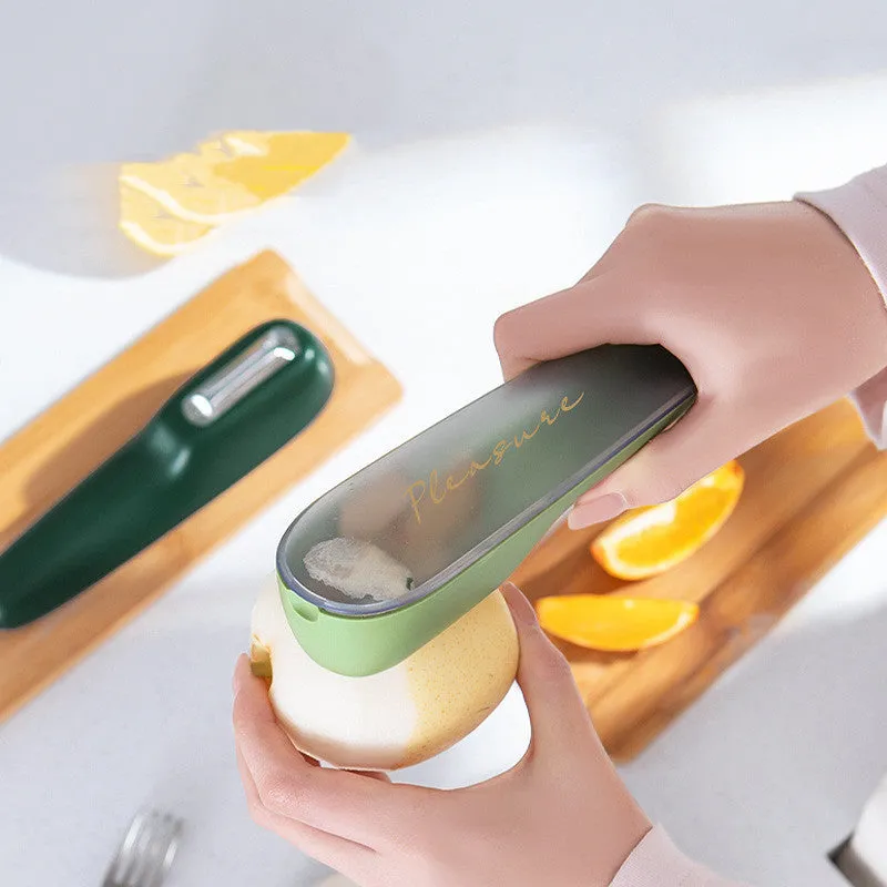 Dark green kitchen peeler with stainless steel blade stored in transparent tube case