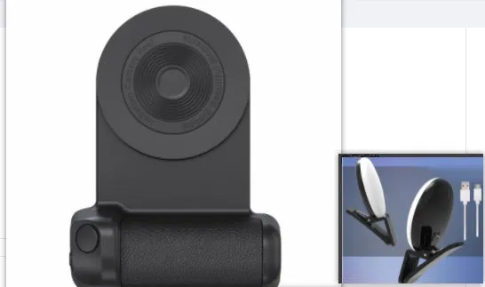 Black magnetic phone camera holder with rotatable bracket and ergonomic leather handle on a table.