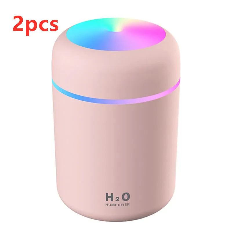 Pink, white, and navy blue USB mini silent humidifier with LED lights on a desk