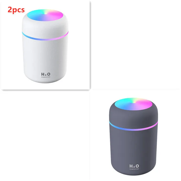 Pink, white, and navy blue USB mini silent humidifier with LED lights on a desk