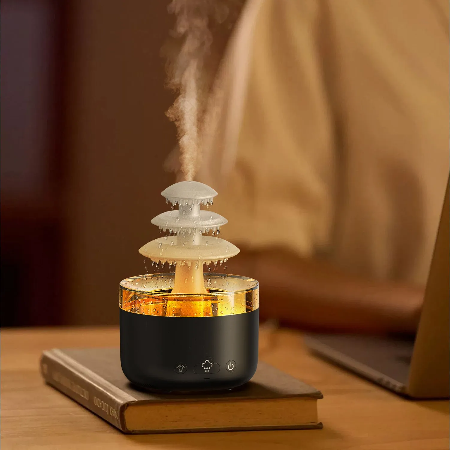 White cloud rain air humidifier and essential oil diffuser with colourful lights on wooden table