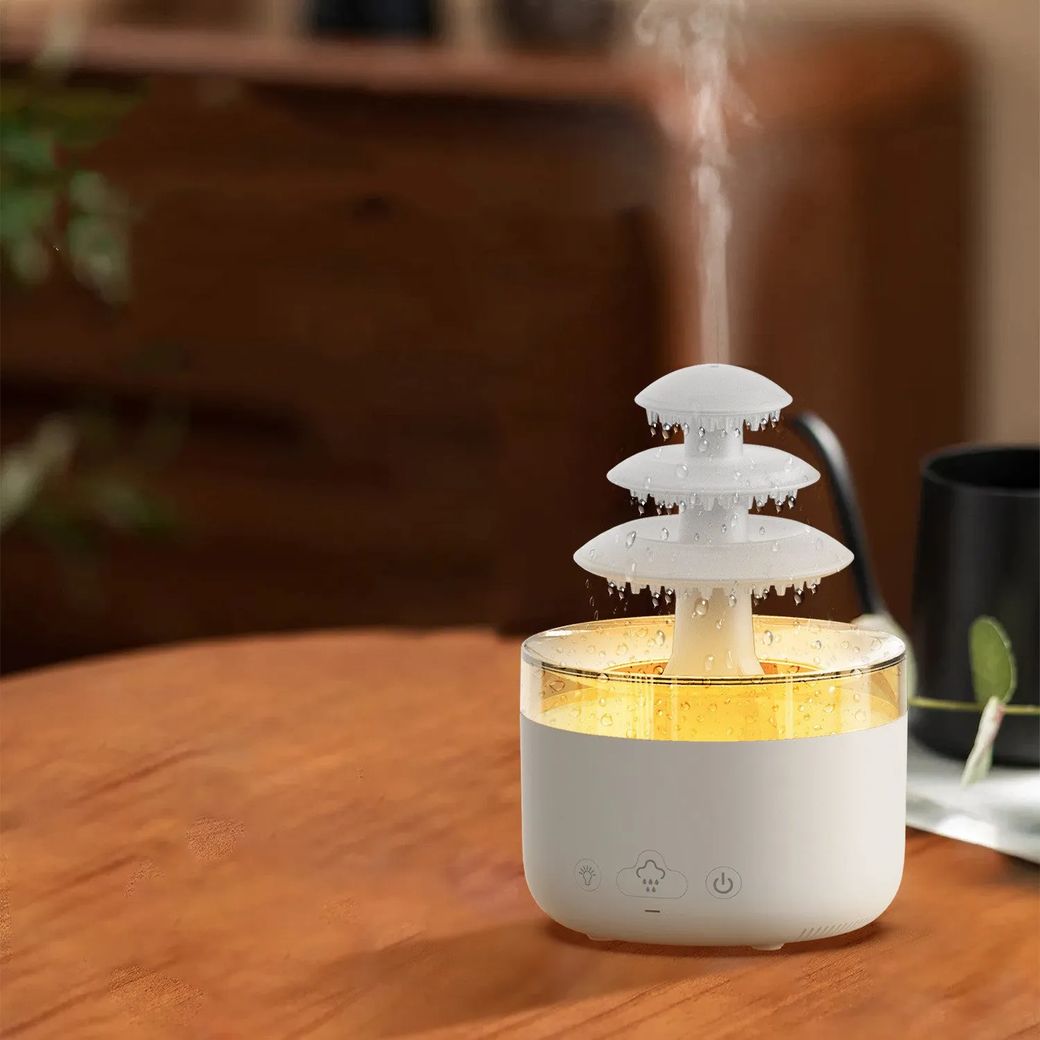White cloud rain air humidifier and essential oil diffuser with colourful lights on wooden table