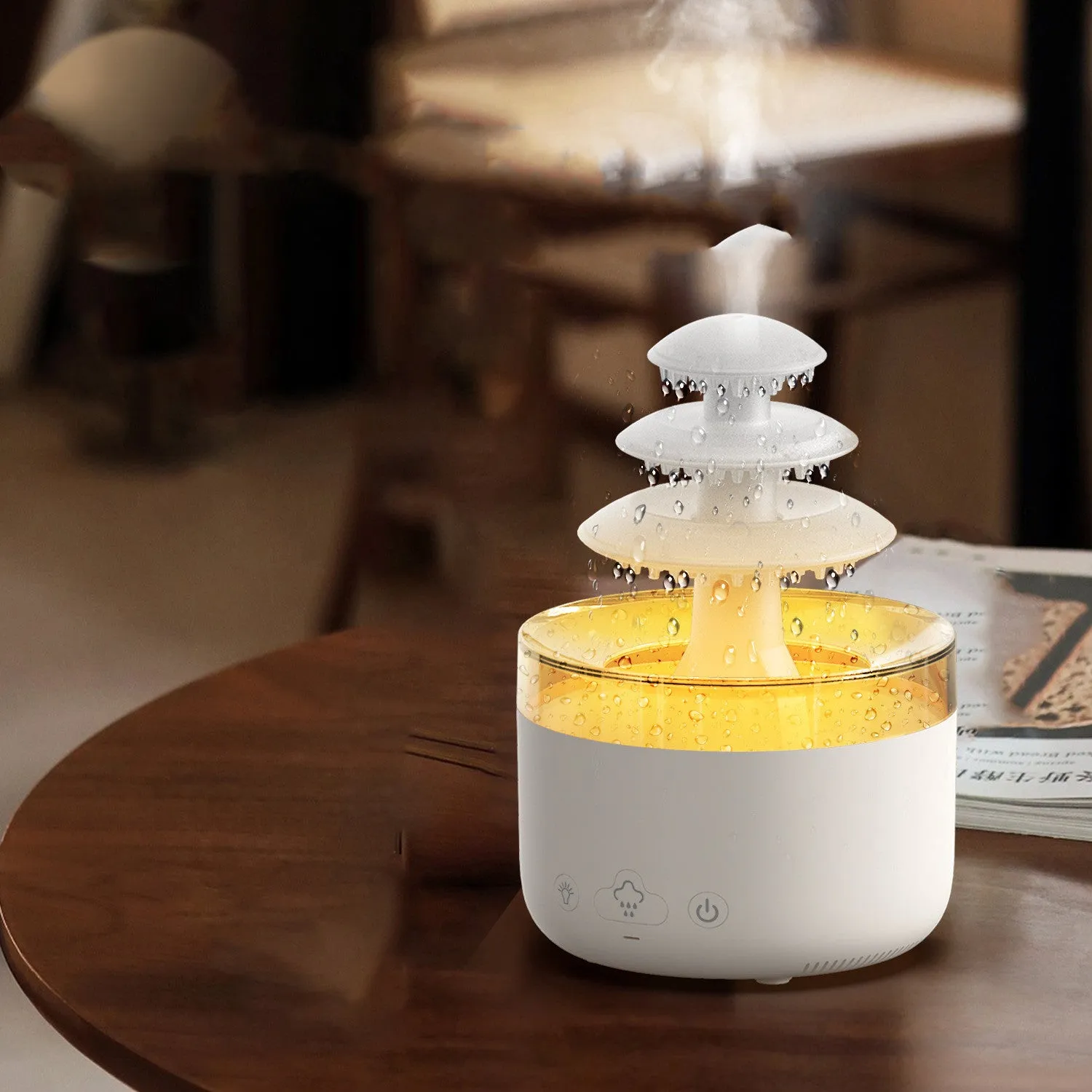 White cloud rain air humidifier and essential oil diffuser with colourful lights on wooden table