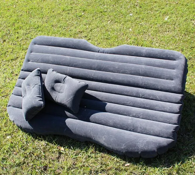 Black inflatable car bed with flocked material laid out in a five-seater vehicle boot.