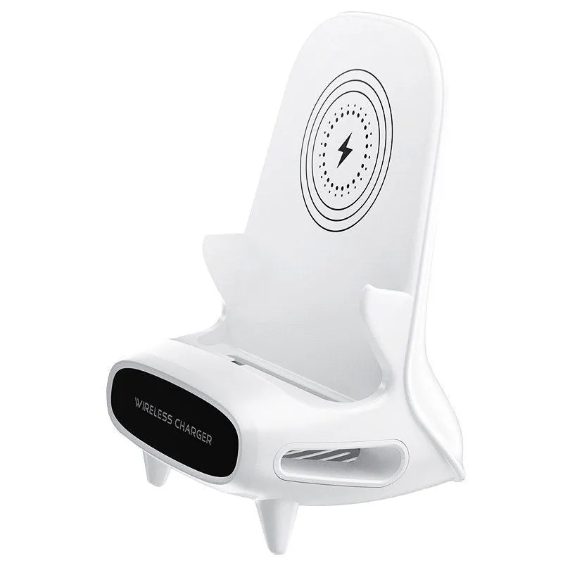 White chair-shaped wireless charging phone stand charging a smartphone on a desk