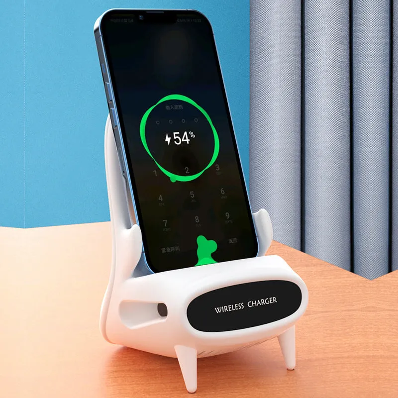 White chair-shaped wireless charging phone stand charging a smartphone on a desk