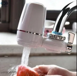 White plastic kitchen tap water filter with ceramic cartridge and universal screw thread adapters