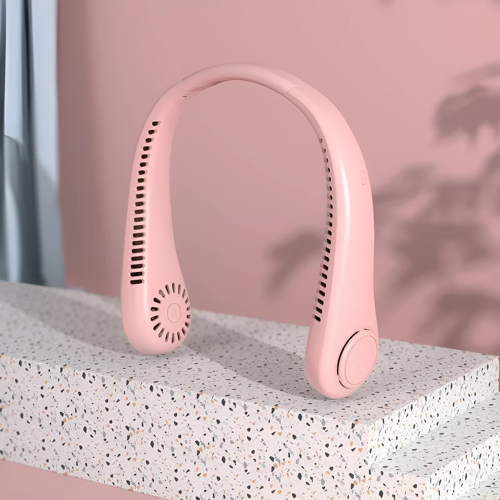 Pink bladeless USB rechargeable neck fan being worn, showing adjustable controls.