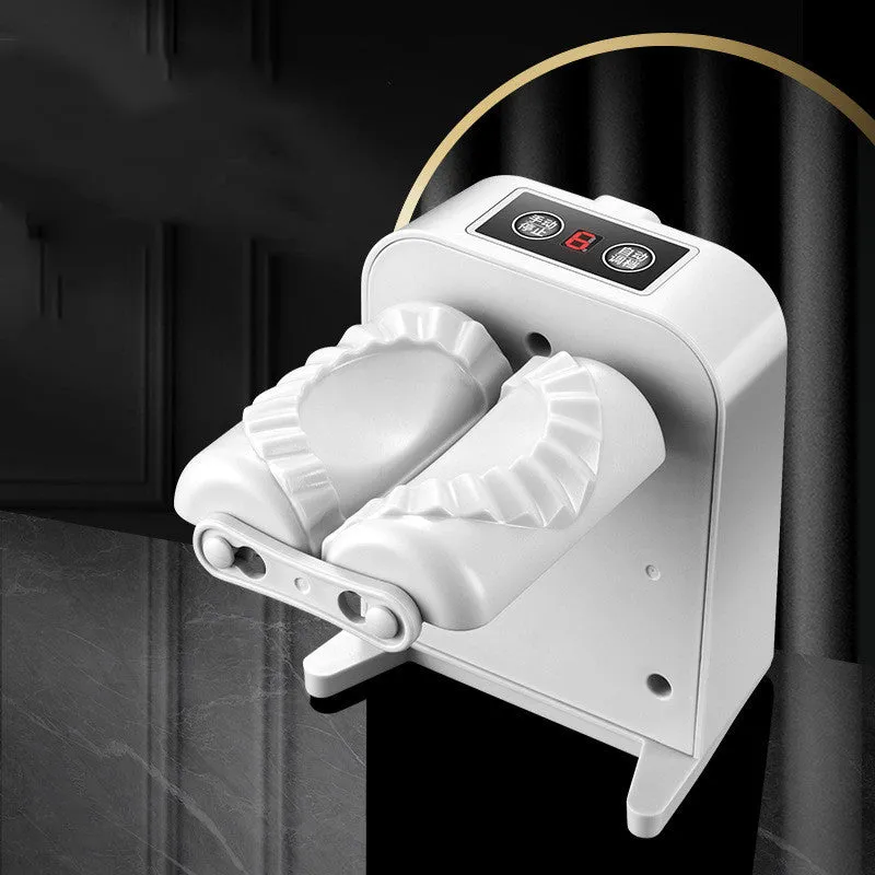 White automatic electric dumpling maker machine with USB cable on a kitchen counter.