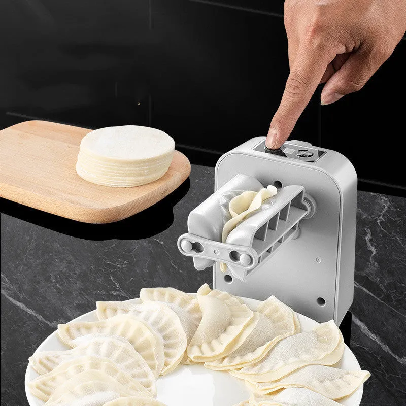 White automatic electric dumpling maker machine with USB cable on a kitchen counter.