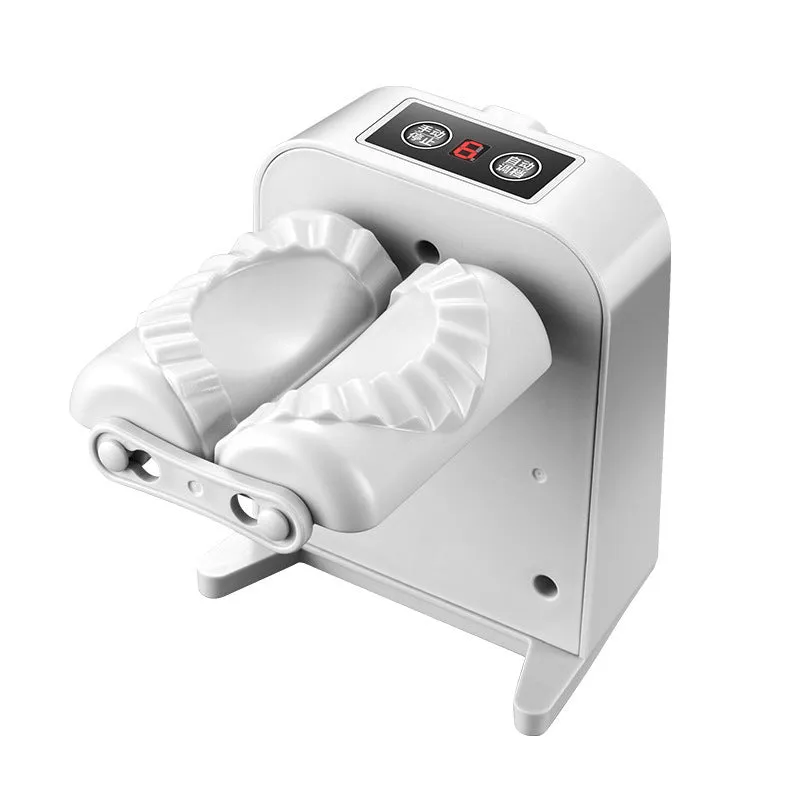 White automatic electric dumpling maker machine with USB cable on a kitchen counter.