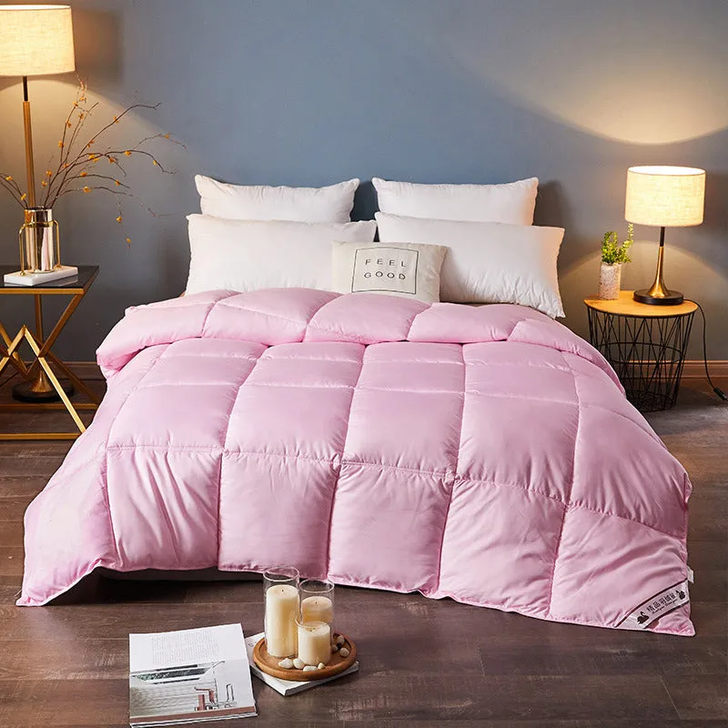 Goose down winter duvet in pink colour on a bed, showing twill weave fabric texture.