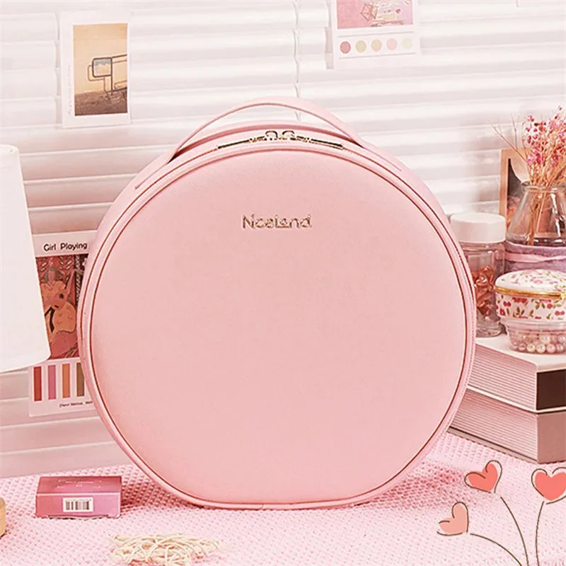Round pink PU leather LED makeup bag open showing internal mirror, lights, and lattice partitions.