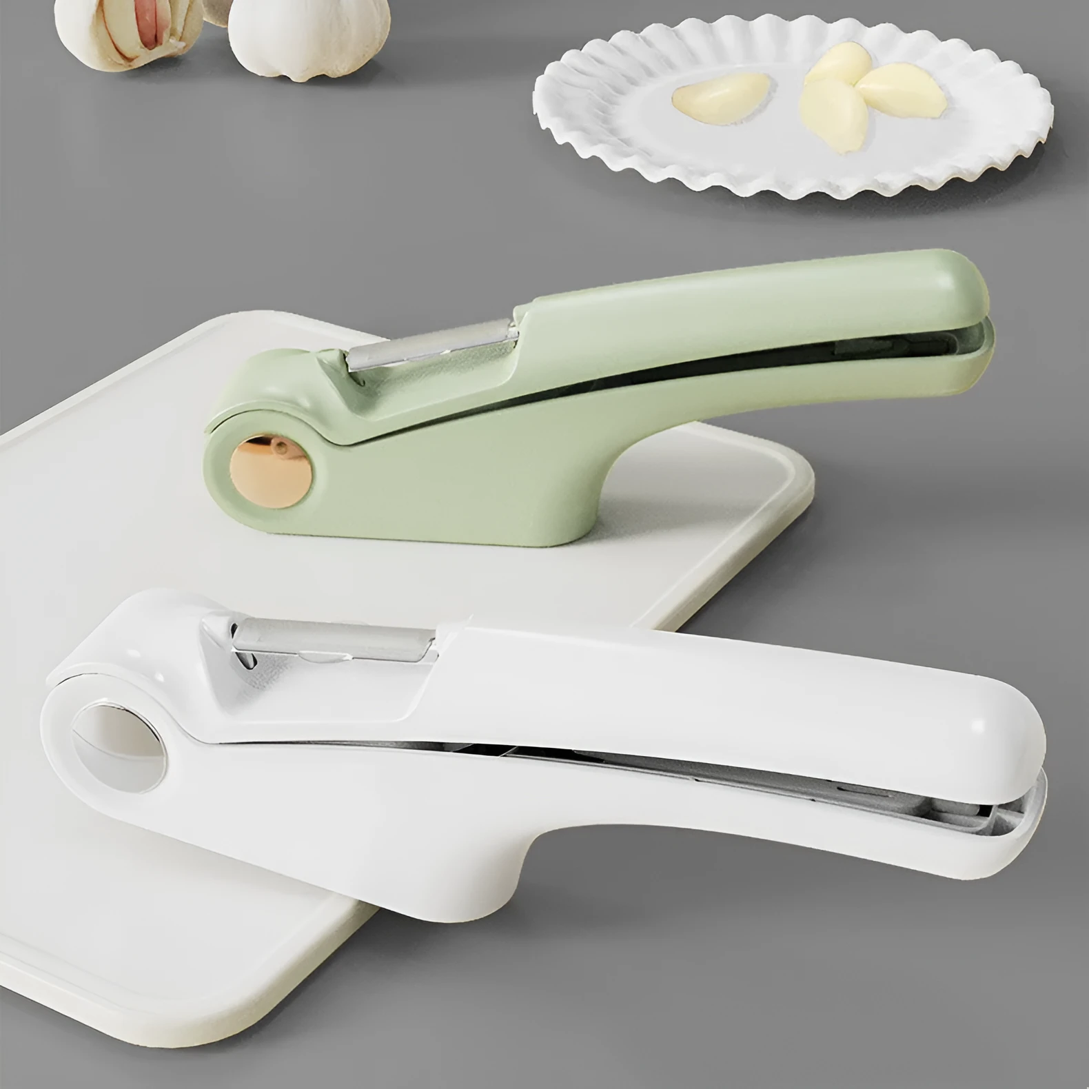 Manual garlic press with stainless steel head and coloured ABS plastic handles