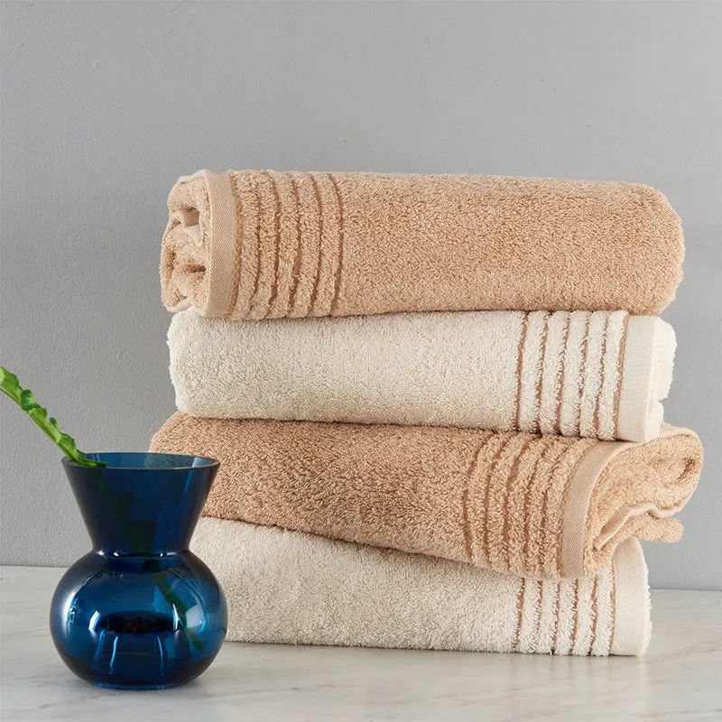 Beige and brown cotton towel set showing small, hand, and bath towel sizes.