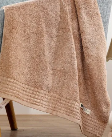 Beige and brown cotton towel set showing small, hand, and bath towel sizes.