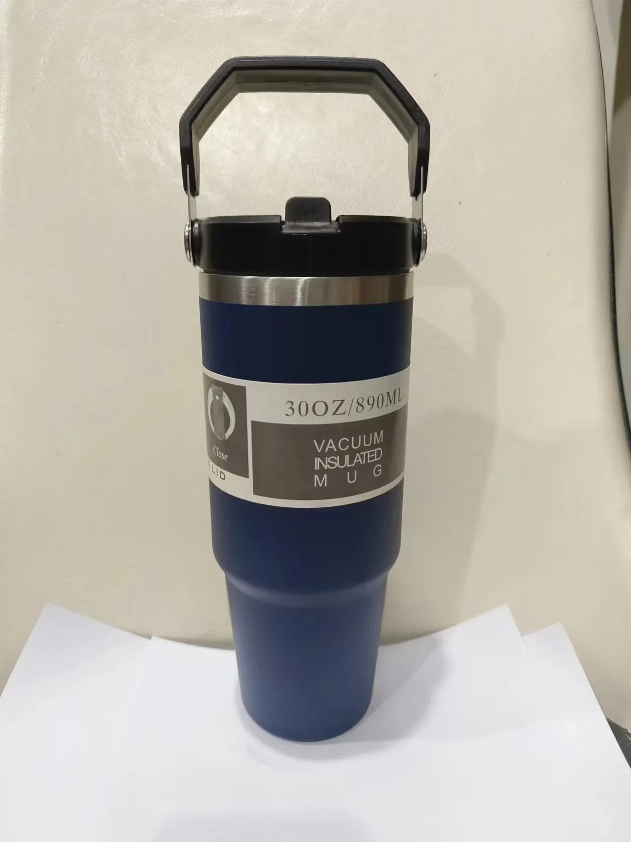 30oz insulated stainless steel travel tumbler with handle, shown in dark pink with a black sliding lid.