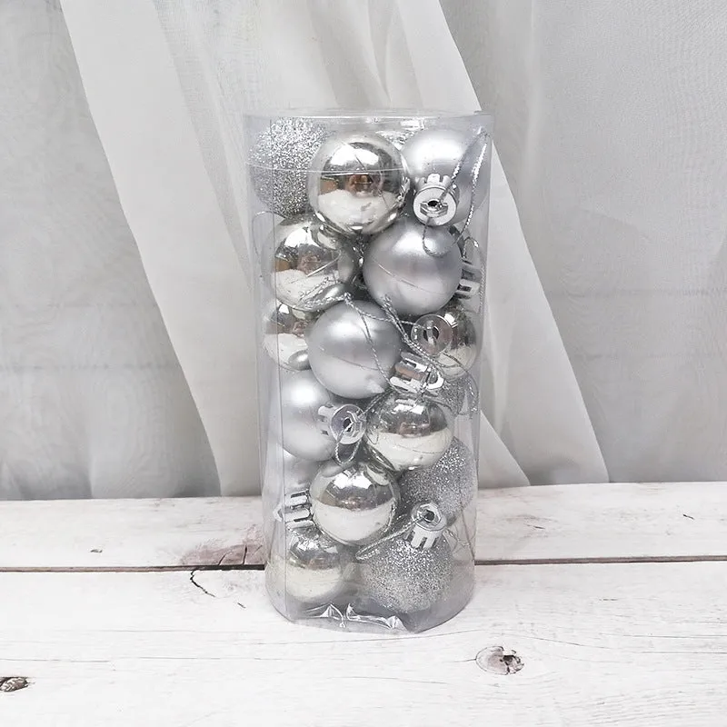 Assorted shiny red, gold, silver, and blue 3 cm Christmas baubles in a box and a storage barrel.