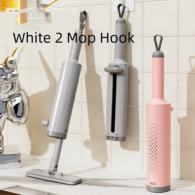 Pink rotatable self-squeeze mini flat mop with microfiber pad, shown extended to its full length.