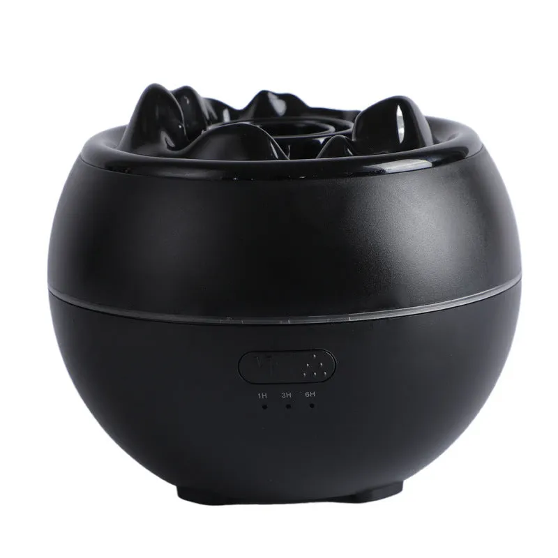 White round flame aroma diffuser humidifier with timer settings on a desk.